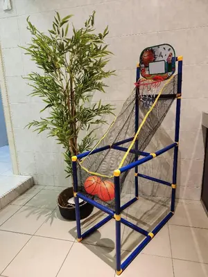 a basketball rackett next to a potted plant at Galaxy Guest Home by Ipoh Maju Stay in Ipoh