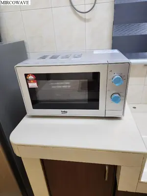 a microwave sitting on top of a table at Galaxy Guest Home by Ipoh Maju Stay in Ipoh