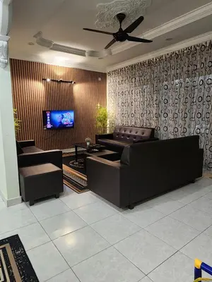 a living room with a couch and a flat screen tv at Galaxy Guest Home by Ipoh Maju Stay in Ipoh
