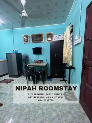 a room with a table and a sign that reads nirvana roomstay at NIPAH ROOMSTAY PARIT BUNTAR in Parit Buntar