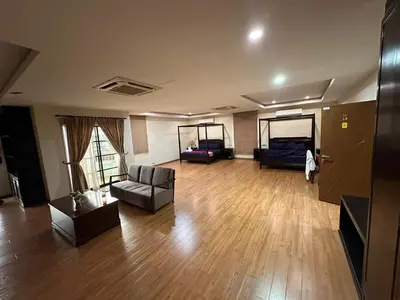 a large living room with a couch and a chair at Maxwell inn in Taiping