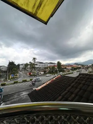 a view of a parking lot with cars on a street at Maxwell inn in Taiping