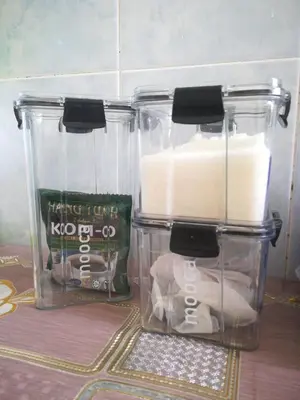 two plastic containers with toilet paper in them on a table at Homestay siti in Padang Serai