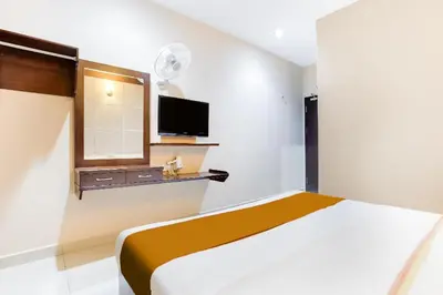 a bedroom with a bed and a tv on the wall at Sejati Hotel in Sitiawan