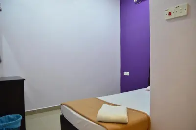 a room with a bed with a towel on it at Deena Hotel Bajet in Gua Musang