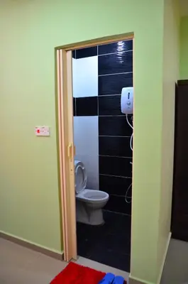 a bathroom with a toilet in a room at Deena Hotel Bajet in Gua Musang