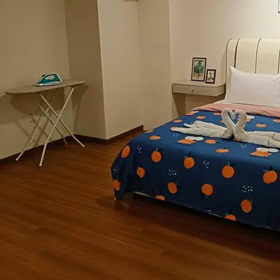 a bedroom with a bed with a blue comforter with oranges at CEO7 Duplex Business Suite#Disneys HS#USM#Pisa#Pantai Hospital in Bayan Lepas