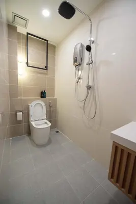 a bathroom with a shower with a toilet and a shower at DeLuma-Lebuh Acheh in George Town