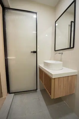 a bathroom with a sink and a mirror at DeLuma-Lebuh Acheh in George Town