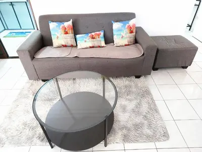 a living room with a couch and a glass table at EC12-Georgetown-3room-PrivateHouse in Jelutong