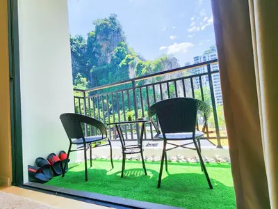 two chairs and a table on a balcony at IPOH The COVE at Ipoh Garden East 7 PAX Cozy Fully Air-Con in Ipoh
