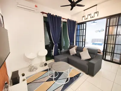a living room with a couch and a table at Studio suite nearby Lost World of Tambun in Tambun