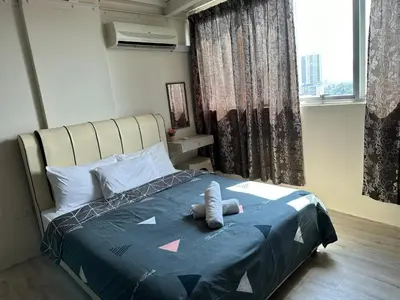 a bedroom with a bed with a stuffed animal on it at CEO9 Duplex Premier 6 Pax Suite#Disneys HS #PISA #USM #Pantai Hospital in Bayan Lepas