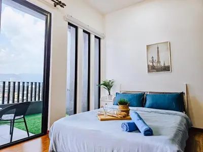 a bedroom with a bed and a large window at Beacon Executive Suite by NGN - Georgetown Penang in George Town