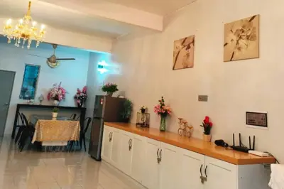 a kitchen with a counter and a table in a room at Homestay Kampar Putra in Kampar