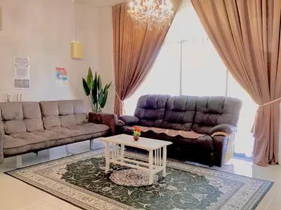 a living room with a couch and a coffee table at Homestay Kampar Putra in Kampar