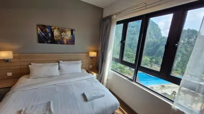 a bedroom with a bed and a large window at H&W Sunway Onsen Suites Services Tambun Ipoh S-15-12 in Ipoh
