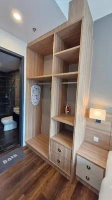 a bathroom with a closet with wooden shelves at H&W Sunway Onsen Suites Services Tambun Ipoh S-15-12 in Ipoh