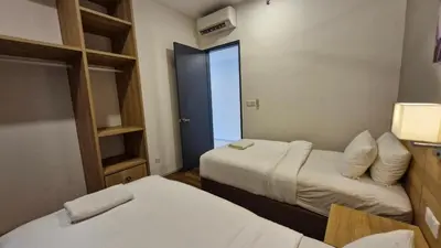 a hotel room with two beds and a window at H&W Sunway Onsen Suites Services Tambun Ipoh S-15-12 in Ipoh