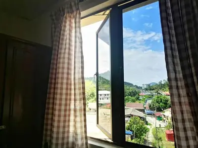 a window with a view of a city at 311 Pangkor Coral Bay Homestay in Pasir Bogak