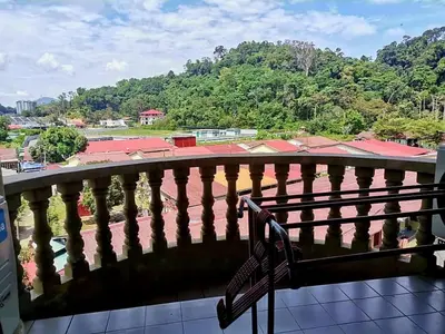 a balcony with a bench and a view of a field at 311 Pangkor Coral Bay Homestay in Pasir Bogak
