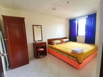 a bedroom with a bed and a mirror and a window at 311 Pangkor Coral Bay Homestay in Pasir Bogak