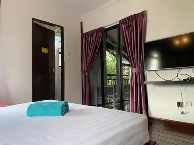 a bedroom with a bed with a blue towel on it at Cahaya Villa in Tanah Rata