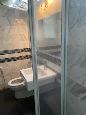 a bathroom with a white sink and a toilet at Cahaya Villa in Tanah Rata