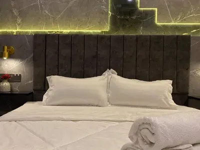 a bed with white pillows and a wooden headboard at SIX Boutique Residence @ Ipoh Garden Landed House 8pax in Ipoh