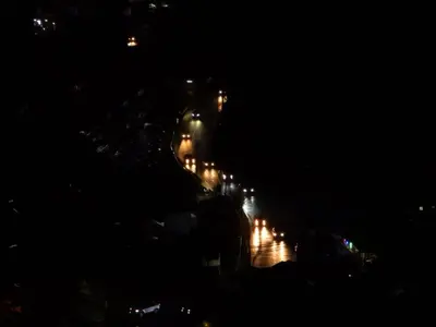 a city at night with lights on a street at The Gladiator Homstay in Brinchang