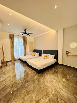 a bedroom with two beds and a ceiling fan at Inn Homestay 2nd Floor Jasmine and Lavender unit in Teluk Intan