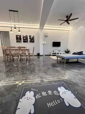 a living room with a table and a dining room at Inn Homestay 2nd Floor Jasmine and Lavender unit in Teluk Intan