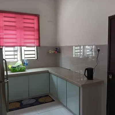 a kitchen with a counter and a red window at Damai Homestay in Kepala Batas