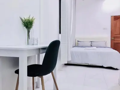 a white bedroom with a desk and a bed at Family 4BR Landed House @ SPICE ARENA in Bayan Lepas