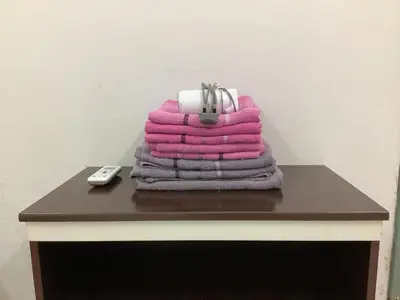 a pile of towels sitting on top of a table at 4 Bedrooms Ipoh Landed House, Ipoh Town in Ipoh