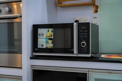 a microwave oven sitting on top of a kitchen counter at GARDEN COZY2STOREY HOME 4ROOM 10PAX@NEAR ALMAJUSCO in Bukit Mertajam