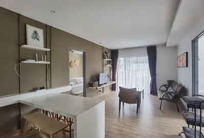 a kitchen and living room with a table and chairs at Emerald Avenue Cozy 3R3B Apartment 830 in Brinchang