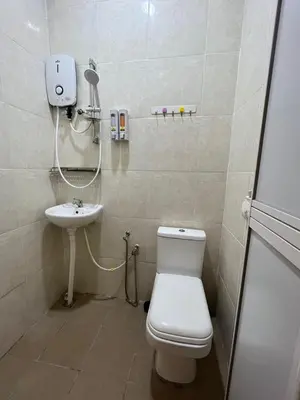 a bathroom with a toilet and a sink at sungai ujong home stay in George Town