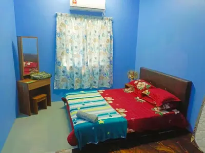 a blue room with a bed and a window at Teratak Desa Umaira in Tanjung Karang