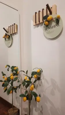 a lemon tree in a room with a clock on the wall at G Residence - Cosy 4R3B Semi-D in Brinchang Town in Brinchang