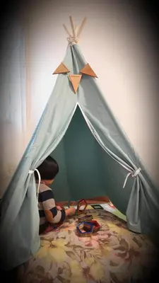 a young boy is playing in a play tent at G Residence - Cosy 4R3B Semi-D in Brinchang Town in Brinchang
