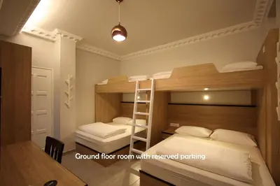 a room with two bunk beds and a ladder at Shamrock Guest House in Ipoh
