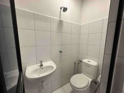 a bathroom with a toilet and a sink at LM HomeyB 3BR Coastline Family Suite for 4-14 Pax with Nexflix & Coway Water Purifier in Tanjong Tokong