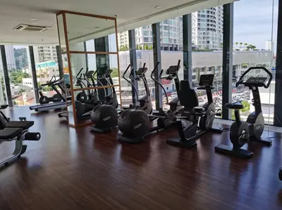 a gym with treadmills and ellipticals in a building at LM HomeyB 3BR Coastline Family Suite for 4-14 Pax with Nexflix & Coway Water Purifier in Tanjong Tokong