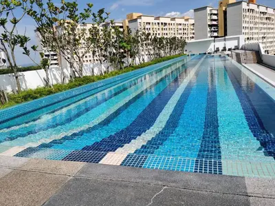 a large swimming pool on top of a building at LM HomeyB 3BR Coastline Family Suite for 4-14 Pax with Nexflix & Coway Water Purifier in Tanjong Tokong