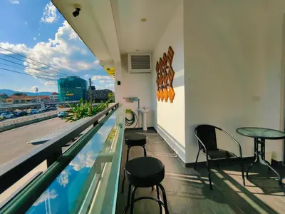 a rooftop bar with chairs and a view of the city at C Boutique Townhouse Station 18 Ipoh By irainbow in Ipoh