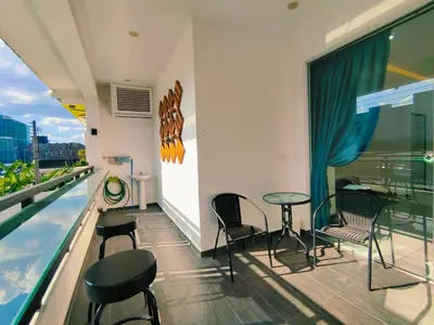 a balcony with a table and chairs and a swimming pool at C Boutique Townhouse Station 18 Ipoh By irainbow in Ipoh