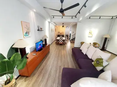 a living room with a purple couch and a tv at (TS) Cozy House 4 Room10Pax@ALMA in Bukit Mertajam