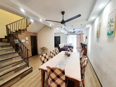 a living room with a table and chairs and a staircase at (TS) Cozy House 4 Room10Pax@ALMA in Bukit Mertajam