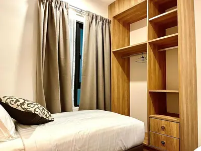 a bedroom with a bed and a book shelf at Onsen Premium Hotspring Suite Sunway Tambun Ipoh in Tambun